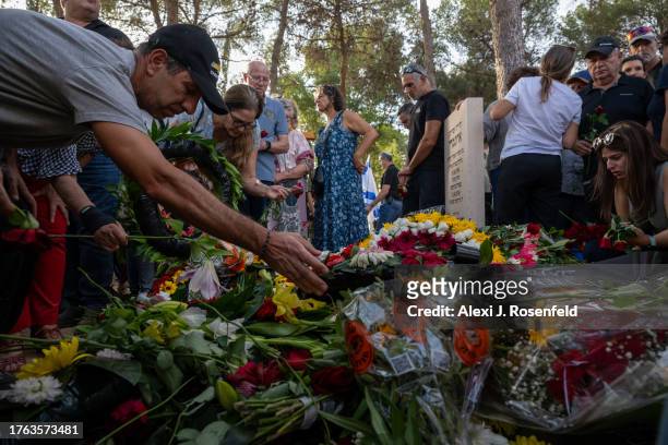 Mourners grieve during the funeral of Lili Itamari and Ram Itamari a couple from Kibbutz Kfar Aza who were killed when Hamas militants attacked the...