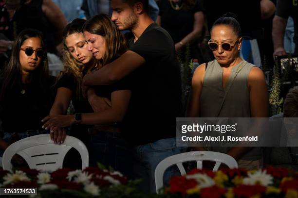 Raz Itamari grieves during the funeral of Lili Itamari and Ram Itamari a couple from Kibbutz Kfar Aza who were killed when Hamas militants attacked...