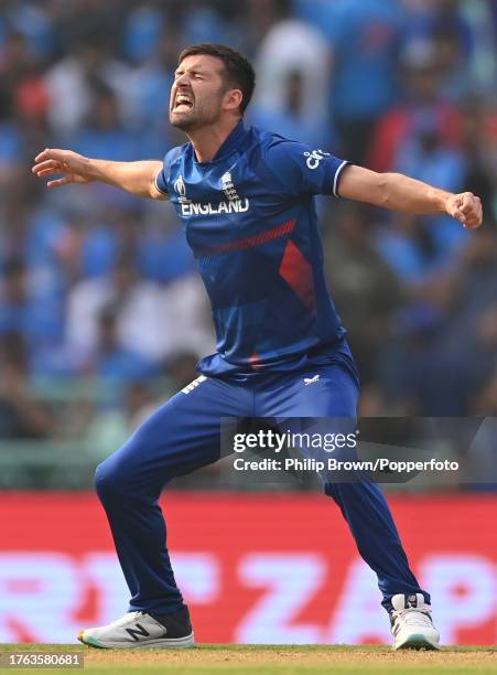 Mark Wood of England celebrates a dismissal although a review overturned the decision during the ICC Men's Cricket World Cup India 2023 between India...