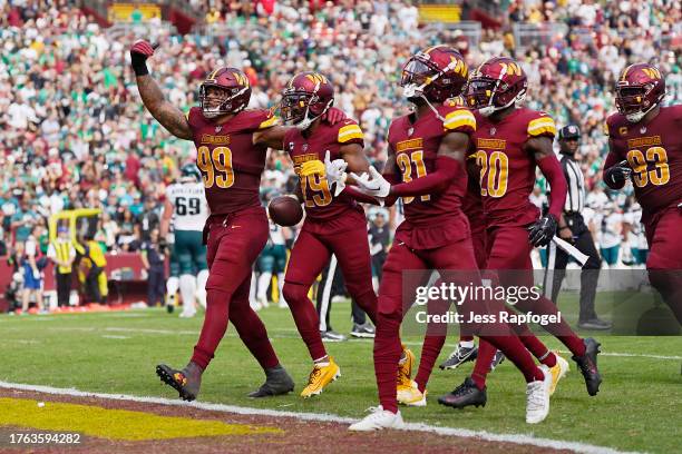 The Washington Commanders defense celebrates after forcing a turnover in the third quarter of a game against the Philadelphia Eagles at FedExField on...