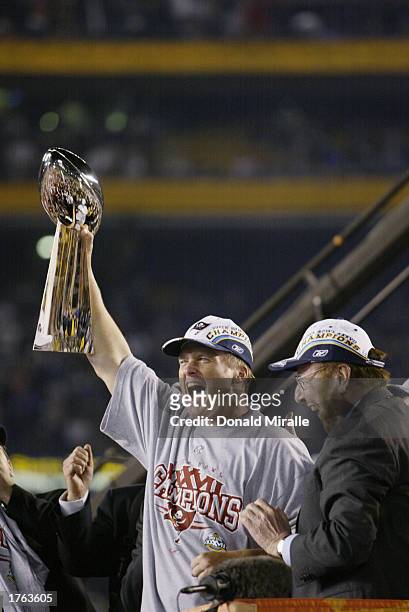 Head coach Jon Gruden of the Tampa Bay Buccaneers holds aloft the Vince Lombardi Trophy after defeating the Oakland Raiders in Super Bowl XXXVII at...