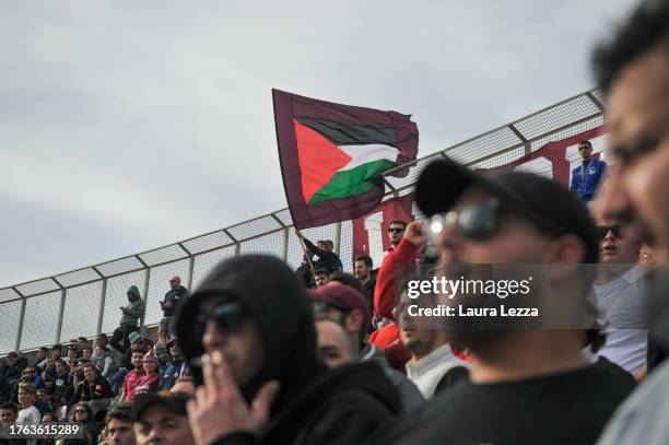 Fans of US Livorno Calcio football team wave a Palestinian flag during the US Livorno V Seravezza match at Armando Picchi stadium on October 29, 2023...