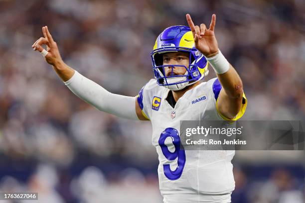 Matthew Stafford of the Los Angeles Rams signals for a two-point conversion after a touchdown in the third quarter of a game against the Dallas...