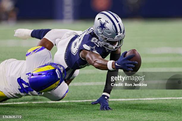 CeeDee Lamb of the Dallas Cowboys stretches out just short of a first down in the fourth quarter of a game against the Los Angeles Rams at AT&T...