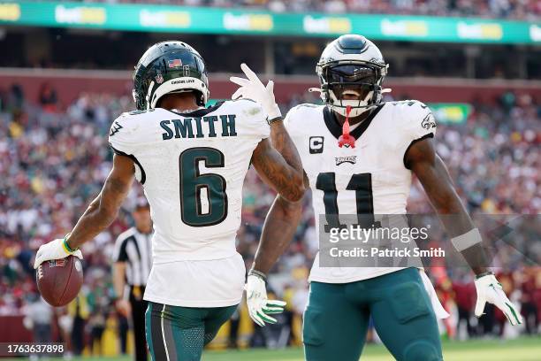 DeVonta Smith of the Philadelphia Eagles celebrates a touchdown with A.J. Brown during the fourth quarter against the Washington Commanders at...