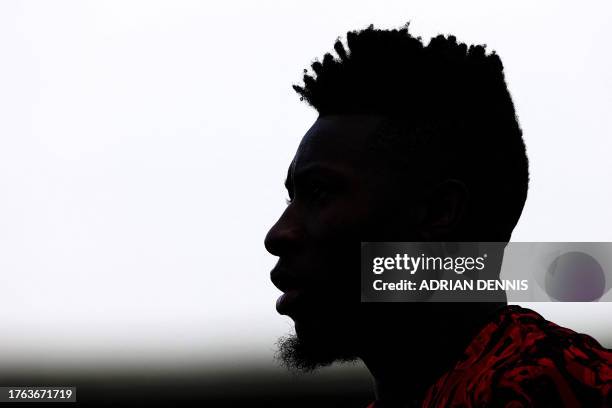 Manchester United's Cameroonian goalkeeper Andre Onana warms up ahead of the English Premier League football match between Fulham and Manchester...