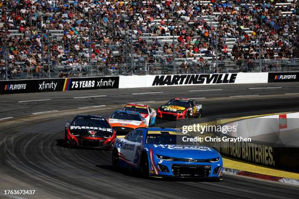 Kyle Larson, driver of the HendrickCars.com Chevrolet, Ross Chastain, driver of the Moose Fraternity Chevrolet, Michael McDowell, driver of the...