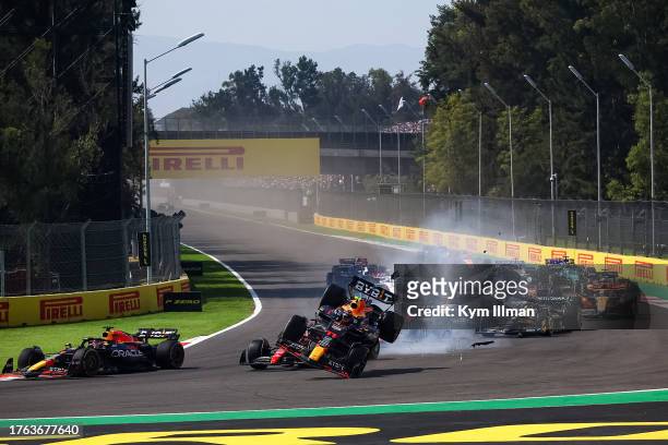 Sergio Perez of Mexico driving the Oracle Red Bull Racing RB19 collides with Charles Leclerc of Monaco driving the Ferrari SF-23 on the opening lap...