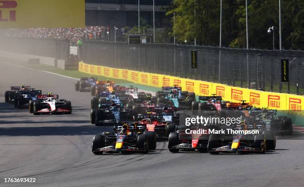 Sergio Perez of Mexico driving the Oracle Red Bull Racing RB19 collides with Charles Leclerc of Monaco driving the Ferrari SF-23 into the first...