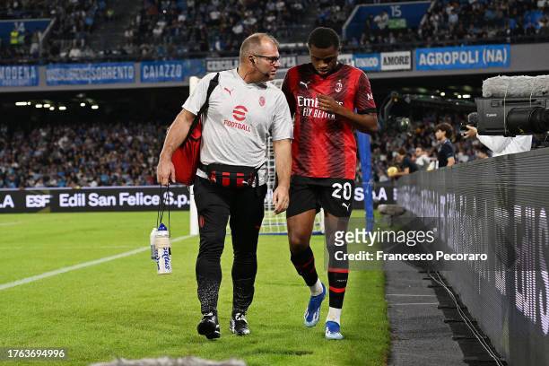 Pierre Kalulu of AC Milan leaves the field dejected having suffered an injury during the Serie A TIM match between SSC Napoli and AC Milan at Stadio...