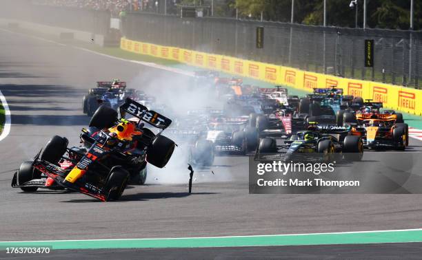 Sergio Perez of Mexico driving the Oracle Red Bull Racing RB19 collides with Charles Leclerc of Monaco driving the Ferrari SF-23 into the first...