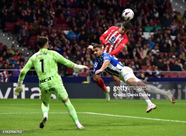 Alvaro Morata of Atletico Madrid wins the header whilst under pressure from Aleksandar Sedlar of Deportivo Alaves during the LaLiga EA Sports match...