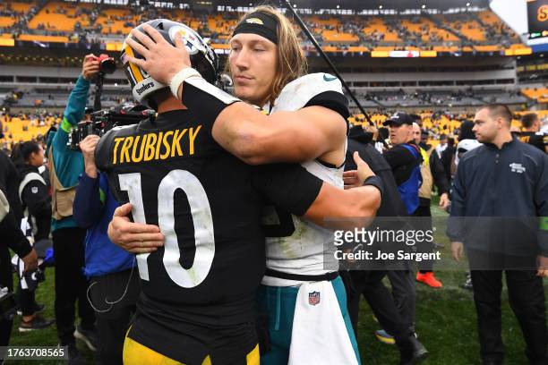 Trevor Lawrence of the Jacksonville Jaguars embraces Mitch Trubisky of the Pittsburgh Steelers after the game at Acrisure Stadium on October 29, 2023...