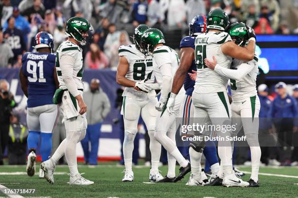 Max Mitchell of the New York Jets hugs Greg Zuerlein of the New York Jets after Zuerlein's game winning field goal in overtime against the New York...