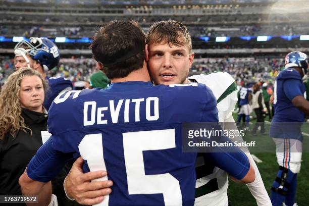 Tommy DeVito of the New York Giants hugs Zach Wilson of the New York Jets after the Jets' 13-10 overtime win at MetLife Stadium on October 29, 2023...
