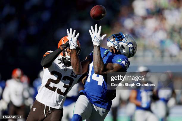 Metcalf of the Seattle Seahawks makes a catch over Martin Emerson Jr. #23 of the Cleveland Browns during the first quarter at Lumen Field on October...