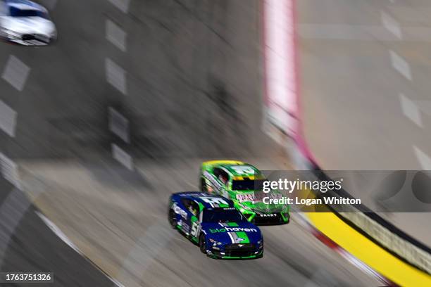 Ryan Newman, driver of the Biohaven/Jacob Co Ford, and Christopher Bell, driver of the Interstate Batteries Toyota, race during the NASCAR Cup Series...