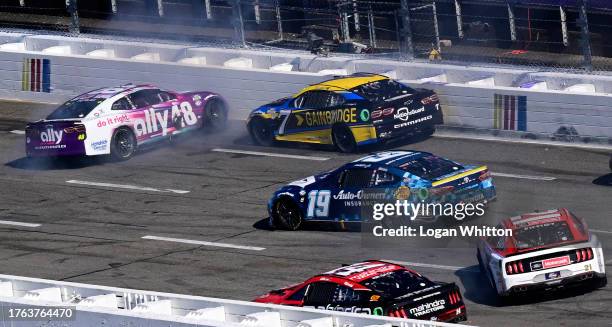 Alex Bowman, driver of the Ally Chevrolet, spins in front of Corey LaJoie, driver of the Gainbridge Chevrolet, Martin Truex Jr., driver of the...