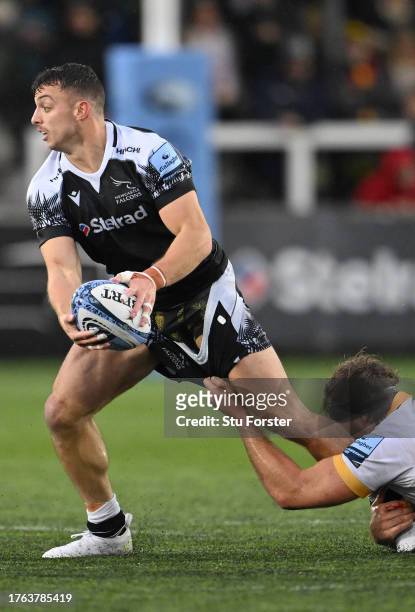 Falcons wing Adam Radwan passes despite being in the grasp of Angus Scott-Young of Saints during the Gallagher Premiership Rugby match between...