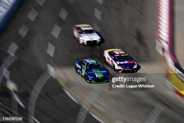 Denny Hamlin, driver of the FedEx Toyota, and Ryan Newman, driver of the Biohaven/Jacob Co Ford, race during the NASCAR Cup Series Xfinity 500 at...