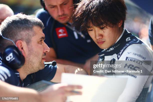 Yuki Tsunoda of Japan and Scuderia AlphaTauri talks with his team in the Pitlane during a red flag period during the F1 Grand Prix of Mexico at...