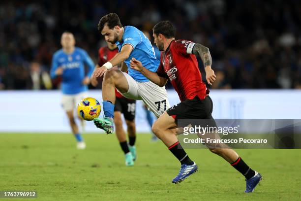Khvicha Kvaratskhelia of SSC Napoli controls the ball whilst under pressure from Davide Calabria of AC Milan during the Serie A TIM match between SSC...