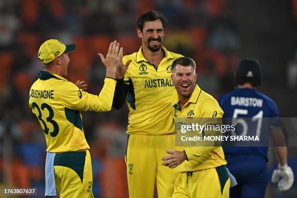 Australia's Mitchell Starc celebrates with teammates after taking the wicket of England's Jonny Bairstow during the 2023 ICC Men's Cricket World Cup...