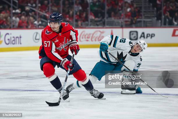 Trevor van Riemsdyk of the Washington Capitals skates with the puck as William Eklund of the San Jose Sharks defends during the first period of the...
