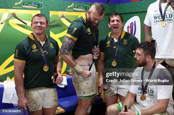 Snyman of South Africa show his tatoo alongside fellow members of the 'Bomb Squad' as they celebrate in the changing room following the team’s...