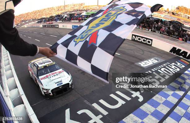 Ryan Blaney, driver of the Discount Tire Ford, takes the checkered flag to win the NASCAR Cup Series Xfinity 500 at Martinsville Speedway on October...