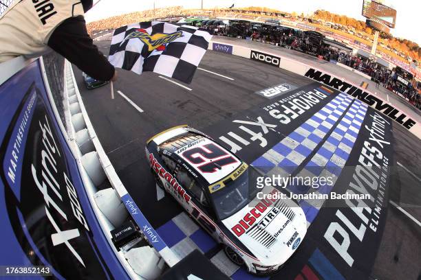 Ryan Blaney, driver of the Discount Tire Ford, takes the checkered flag to win the NASCAR Cup Series Xfinity 500 at Martinsville Speedway on October...