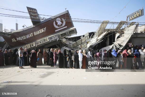View of a partially collapsed, still operational bakehouse in Nuseirat refugee camp in Deir al Balah, Gaza as civilians line up for bread on November...