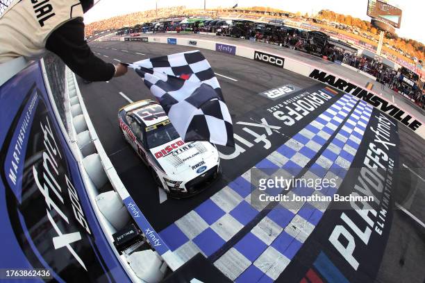 Ryan Blaney, driver of the Discount Tire Ford, takes the checkered flag to win the NASCAR Cup Series Xfinity 500 at Martinsville Speedway on October...