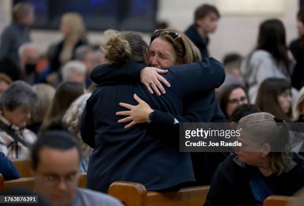 Mourners gather at the Basilica of Saints Peter and Paul for a remembrance ceremony on October 29, 2023 in Lewiston, Maine. The ceremony was held to...