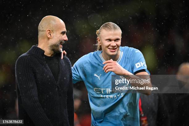 Manchester City manager Pep Guardiola talks to Erling Haaland after the Premier League match between Manchester United and Manchester City at Old...