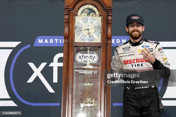 Ryan Blaney, driver of the Discount Tire Ford, celebrates in victory lane after winning the NASCAR Cup Series Xfinity 500 at Martinsville Speedway on...