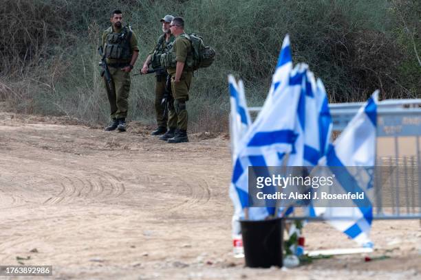 Soldiers stand guard near the entrance to the funeral for Lili Itamari and Ram Itamari a couple from Kibbutz Kfar Aza who were killed in the Hamas...