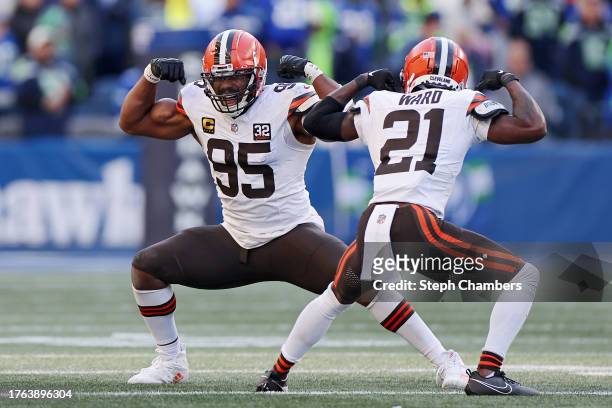Myles Garrett of the Cleveland Browns celebrates a third quarter sack with Denzel Ward of the Cleveland Browns during a game against the Seattle...
