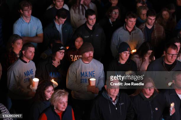 An overflow crowd watches a television screen as it broadcasts from inside the Basilica of Saints Peter and Paul the remembrance ceremony on October...
