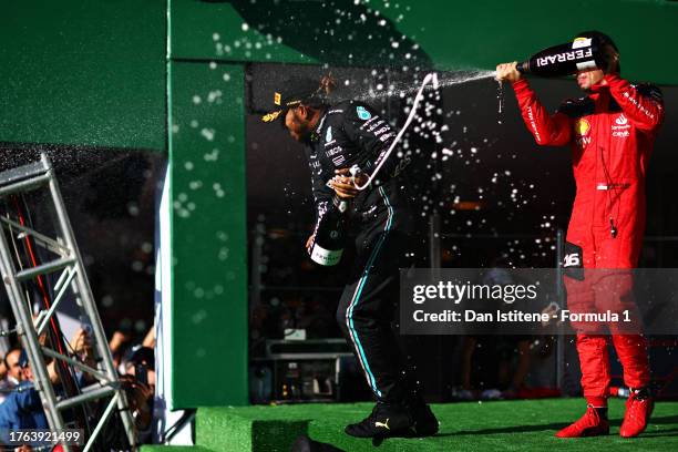 Second placed Lewis Hamilton of Great Britain and Mercedes and Third placed Charles Leclerc of Monaco and Ferrari celebrate on the podium after the...