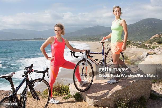 Cycling champions Marion Rousse and Pauline Ferrand-Prevot are photographed for Paris Match on May 15, 2013 in Ajaccio, France.