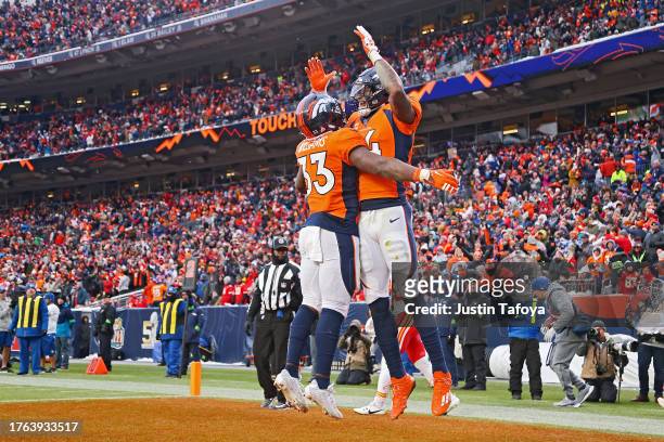 Courtland Sutton celebrates a touchdown with Javonte Williams of the Denver Broncos during the fourth quarter of a game against the Kansas City...