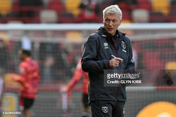 West Ham United's Scottish manager David Moyes watches his players warm up ahead of the English Premier League football match between Brentford and...