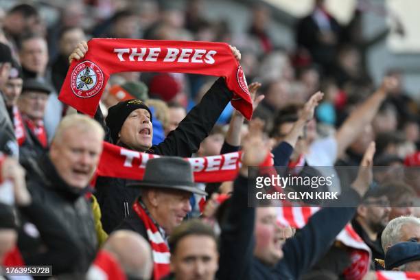 Brentford fans cheer their team on ahead of kick-off in the English Premier League football match between Brentford and West Ham United at Gtech...