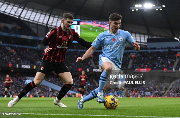 Manchester City's Argentinian striker Julian Alvarez runs with the ball during the English Premier League football match between Manchester City and...