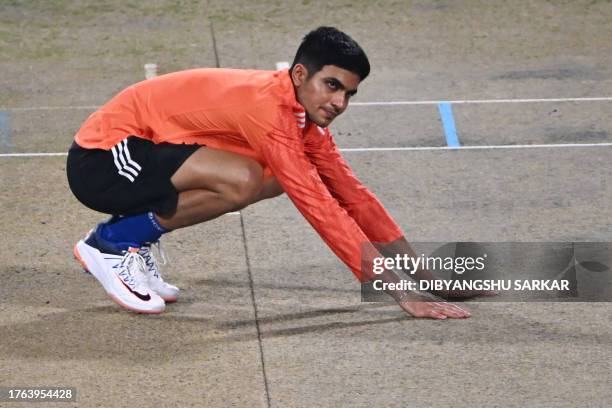 India's Subhman Gill checks the pitch during a practice session at the Eden Gardens Cricket Stadium in Kolkata on November 4 ahead of the 2023 ICC...