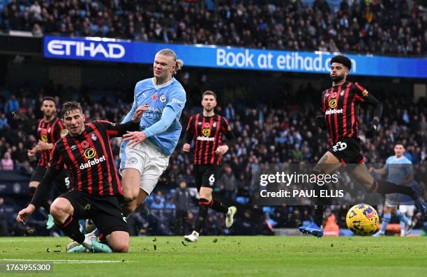 Bournemouth's Danish midfielder Philip Billing tackles Manchester City's Norwegian striker Erling Haaland during the English Premier League football...