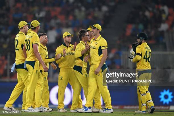 Australia's Adam Zampa celebrates with teammates after taking the wicket of England's Ben Stokes during the 2023 ICC Men's Cricket World Cup one-day...