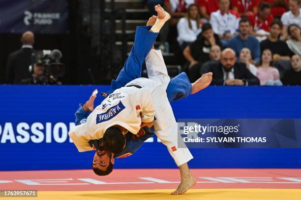 Turkey's Vedat Albayrak throws Georgia's Tato Grigalashvili to make an ippon during the men's under 81 kg final during the European Judo...