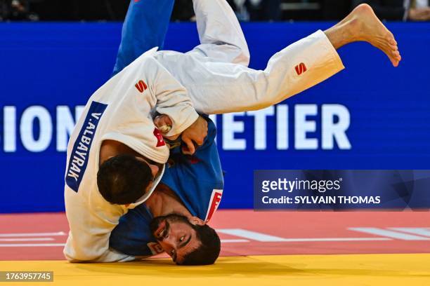 Turkey's Vedat Albayrak throws Georgia's Tato Grigalashvili to make an ippon during the men's under 81 kg final during the European Judo...